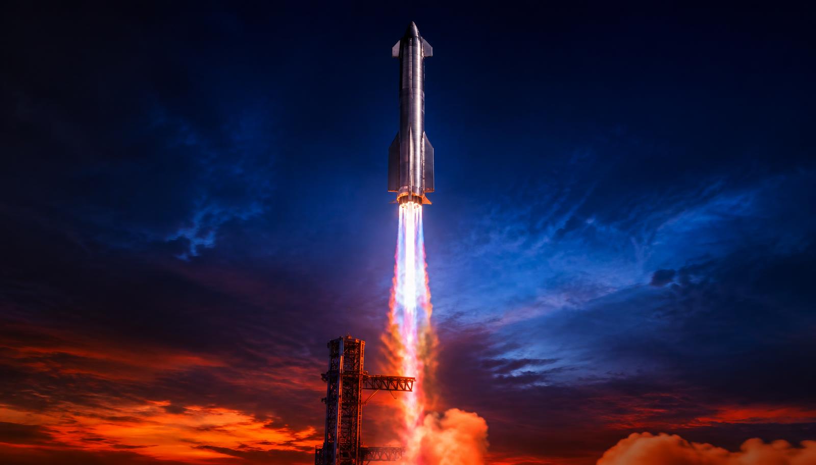 Starship lifting off from its launch tower at dusk